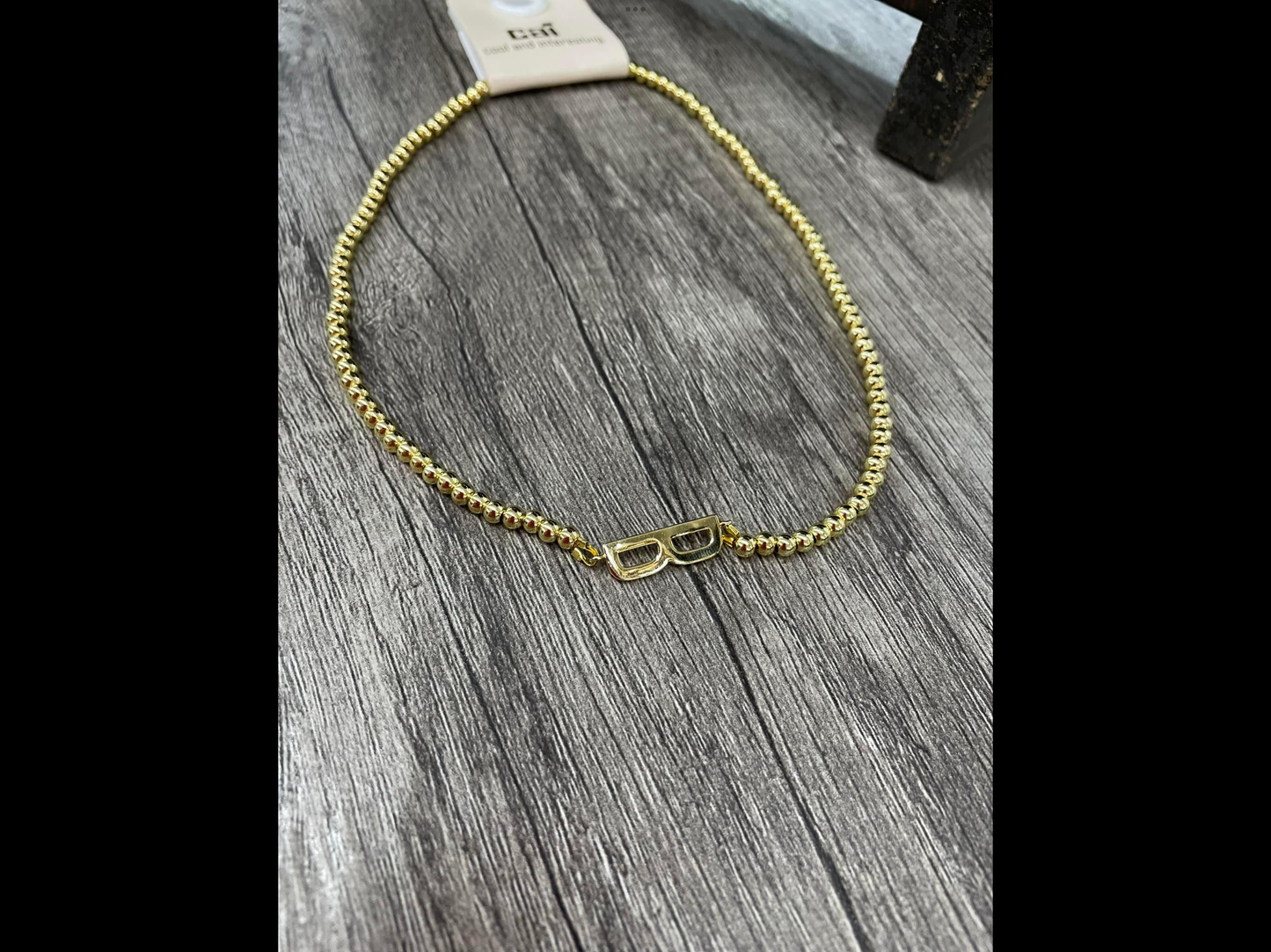 Gold beads on beads sideways initial necklace