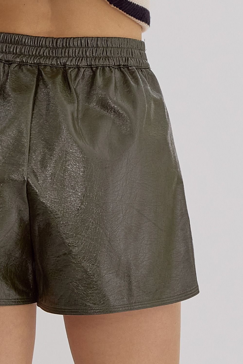 Metallic texture, high waisted shorts w/ elastic waist, pockets, & zipper front closure