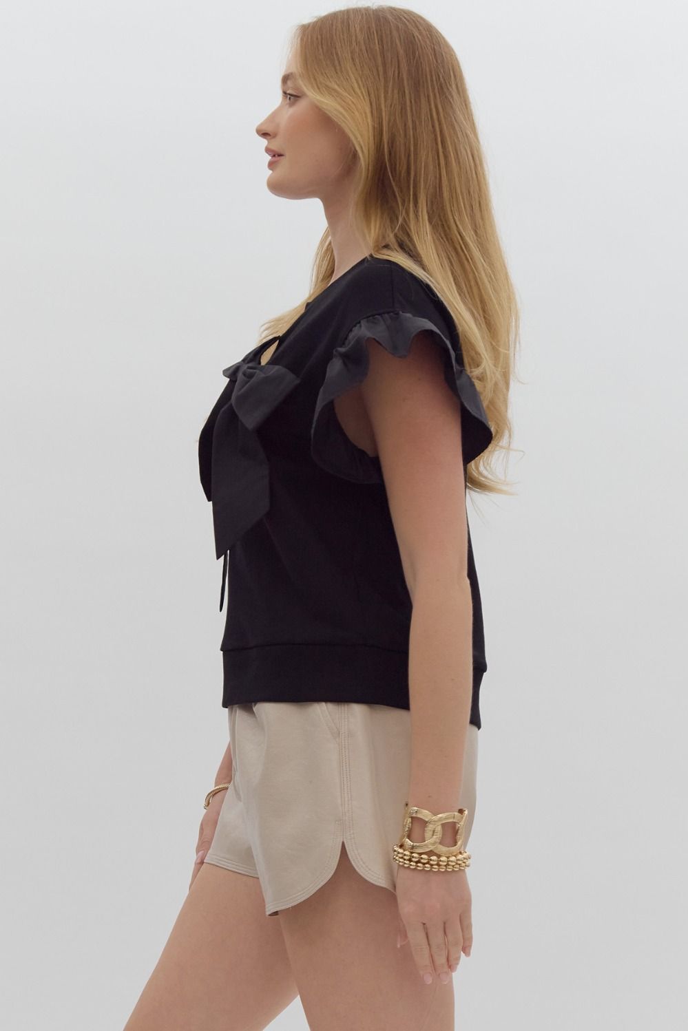 Solid short sleeve round neck top w/ ruffled sleeves. Ribbon detail @ bust.