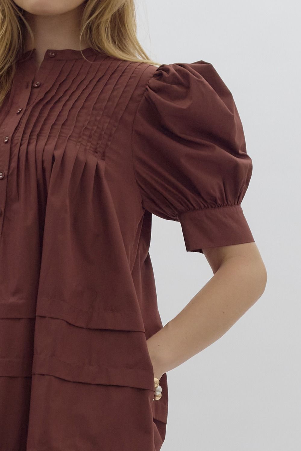 Solid pin tucked short sleeve mini dress w/ pockets, puff sleeves, & button detail at bust