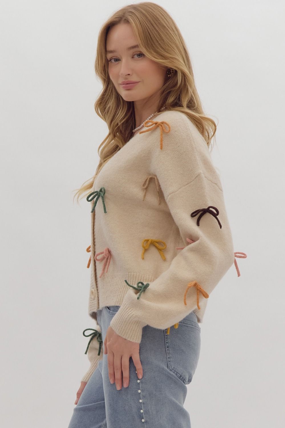 Solid long sleeve button down cropped cardigan w/ multi color bow appliqués