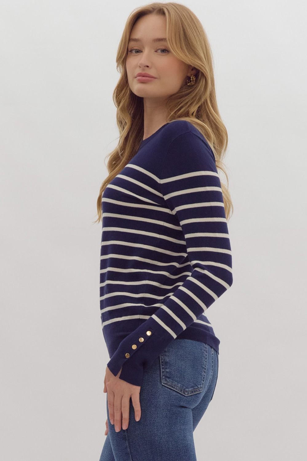 Navy stripe print long sleeve round neck top w/ button up detail at cuff.