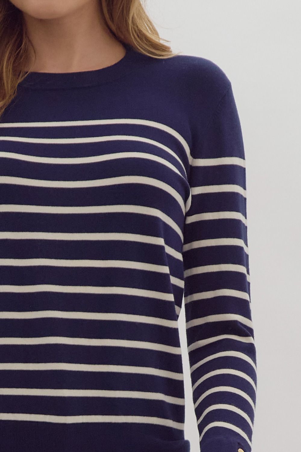Navy stripe print long sleeve round neck top w/ button up detail at cuff.