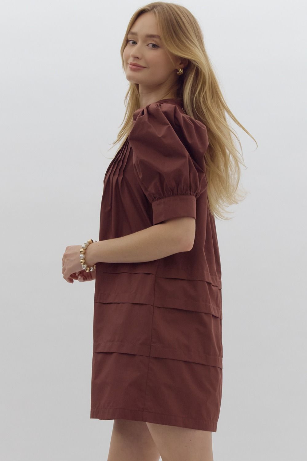 Solid pin tucked short sleeve mini dress w/ pockets, puff sleeves, & button detail at bust