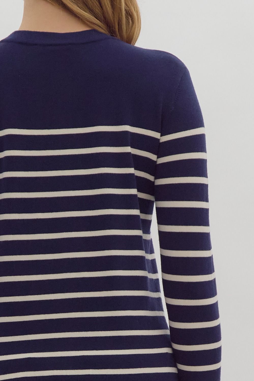 Navy stripe print long sleeve round neck top w/ button up detail at cuff.