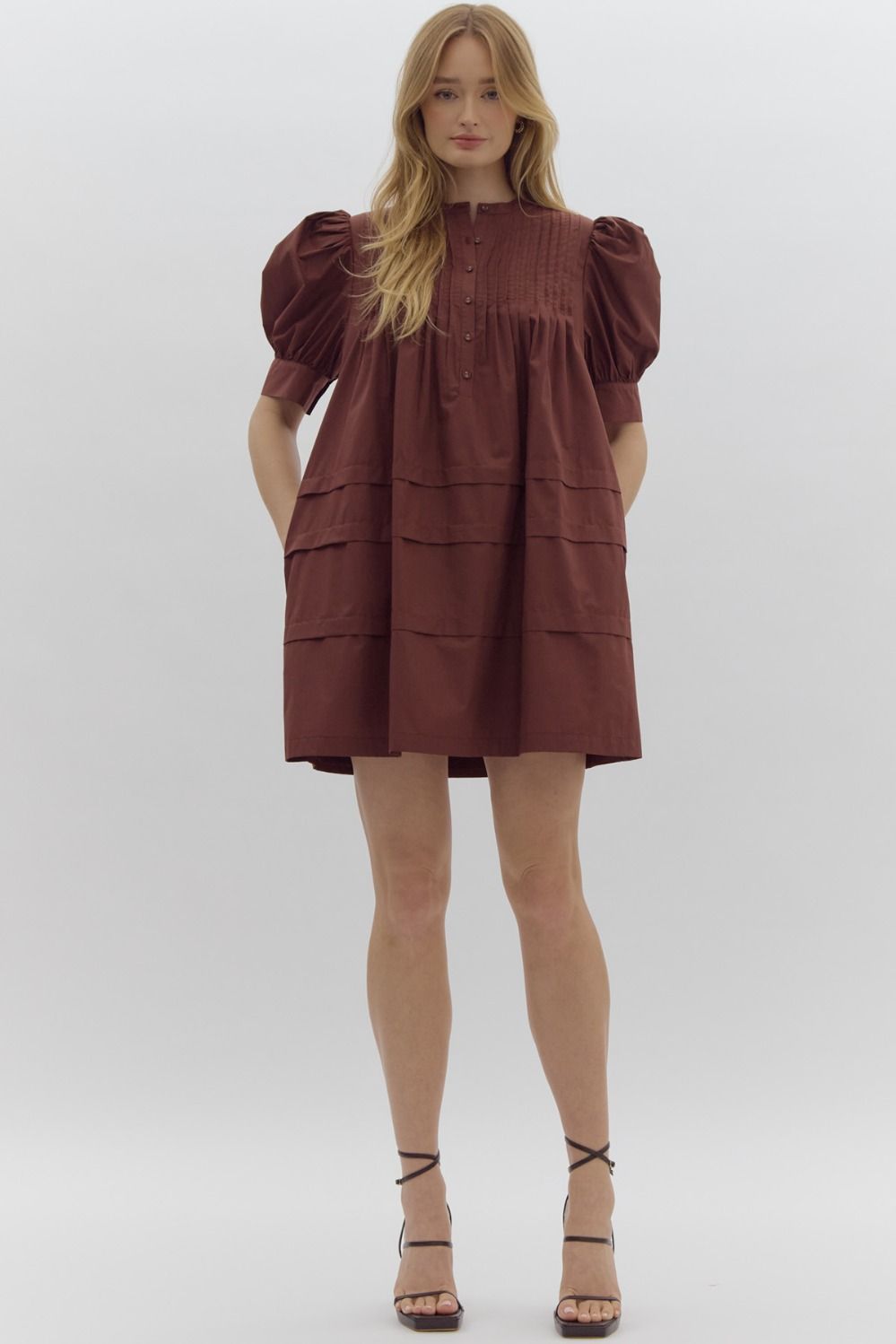 Solid pin tucked short sleeve mini dress w/ pockets, puff sleeves, & button detail at bust
