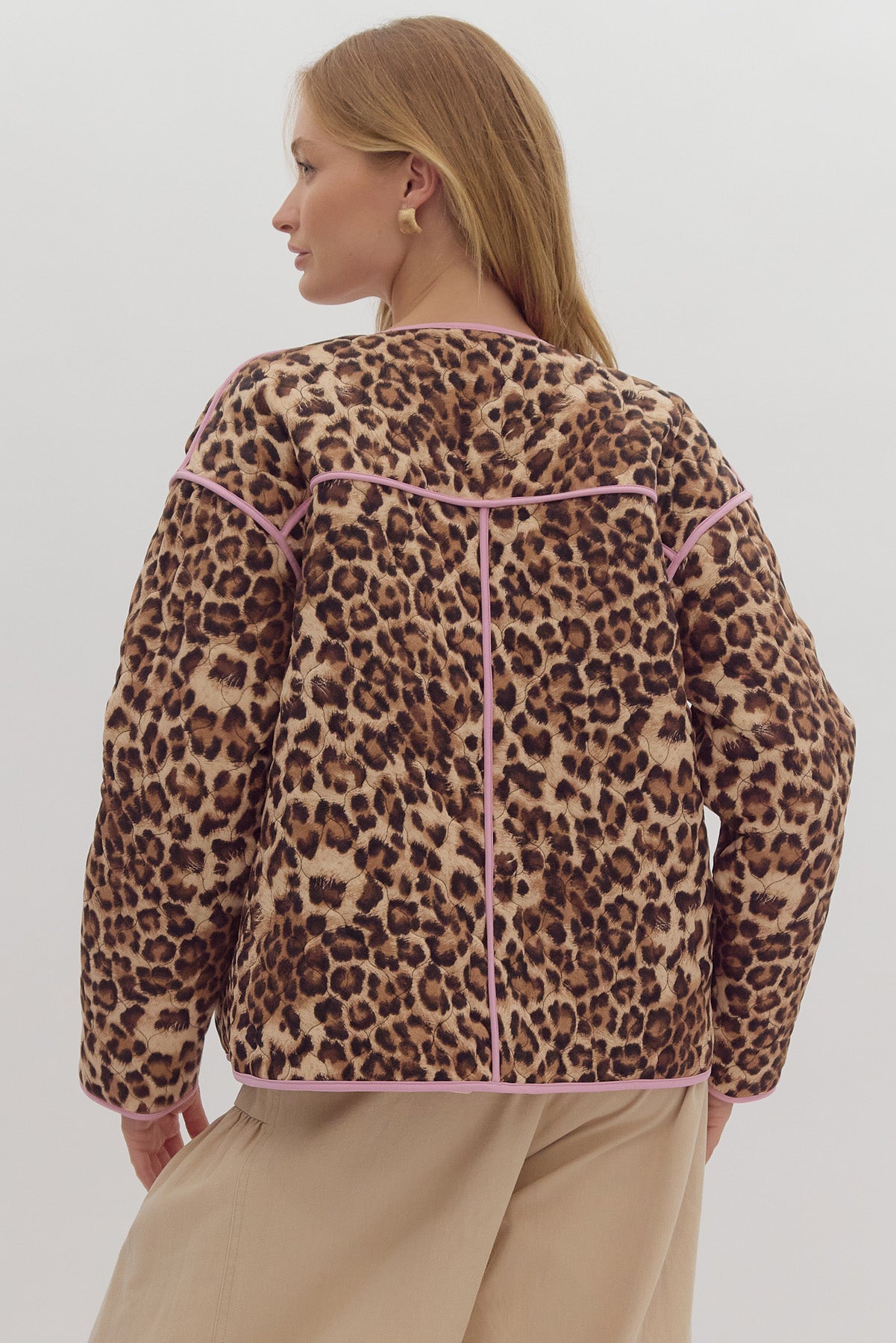 Leopard print long sleeve snap buttons jacket w/ pockets at side. Contrast trim.