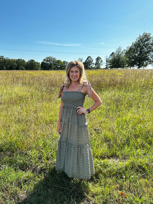 Floral print sq. neck sleeveless tiered midi dress w/ ties at shoulders. Smocking. Pockets.