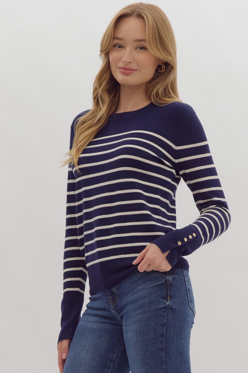 Navy stripe print long sleeve round neck top w/ button up detail at cuff.