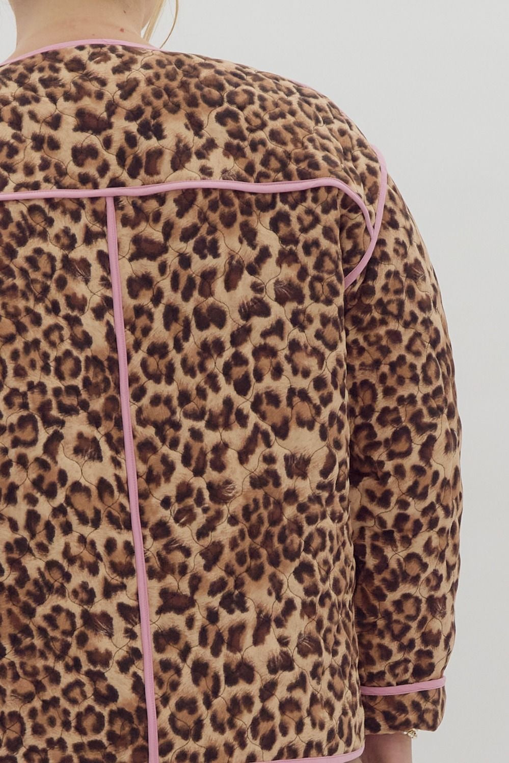 Leopard print long sleeve snap buttons jacket w/ pockets at side. Contrast trim.