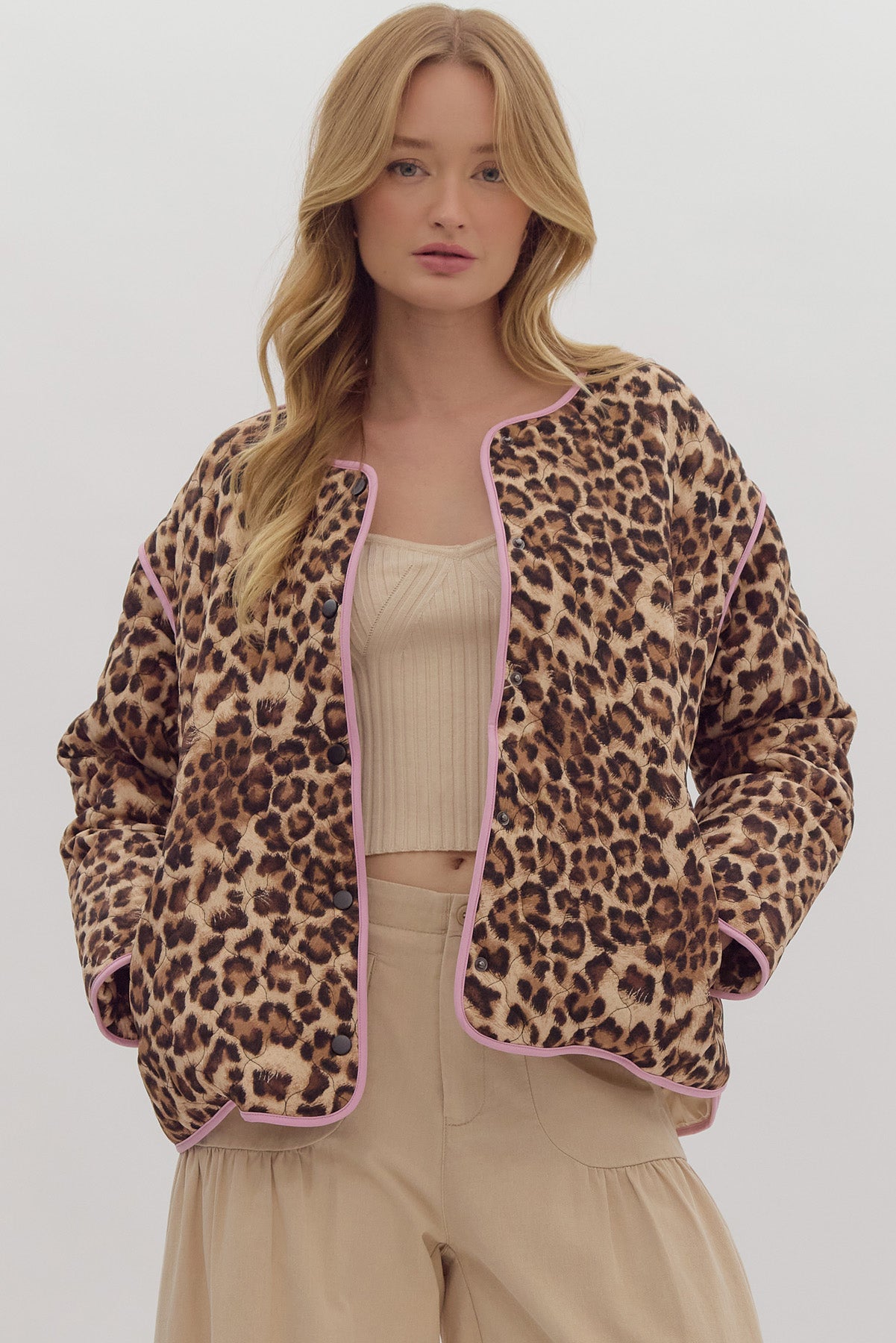 Leopard print long sleeve snap buttons jacket w/ pockets at side. Contrast trim.