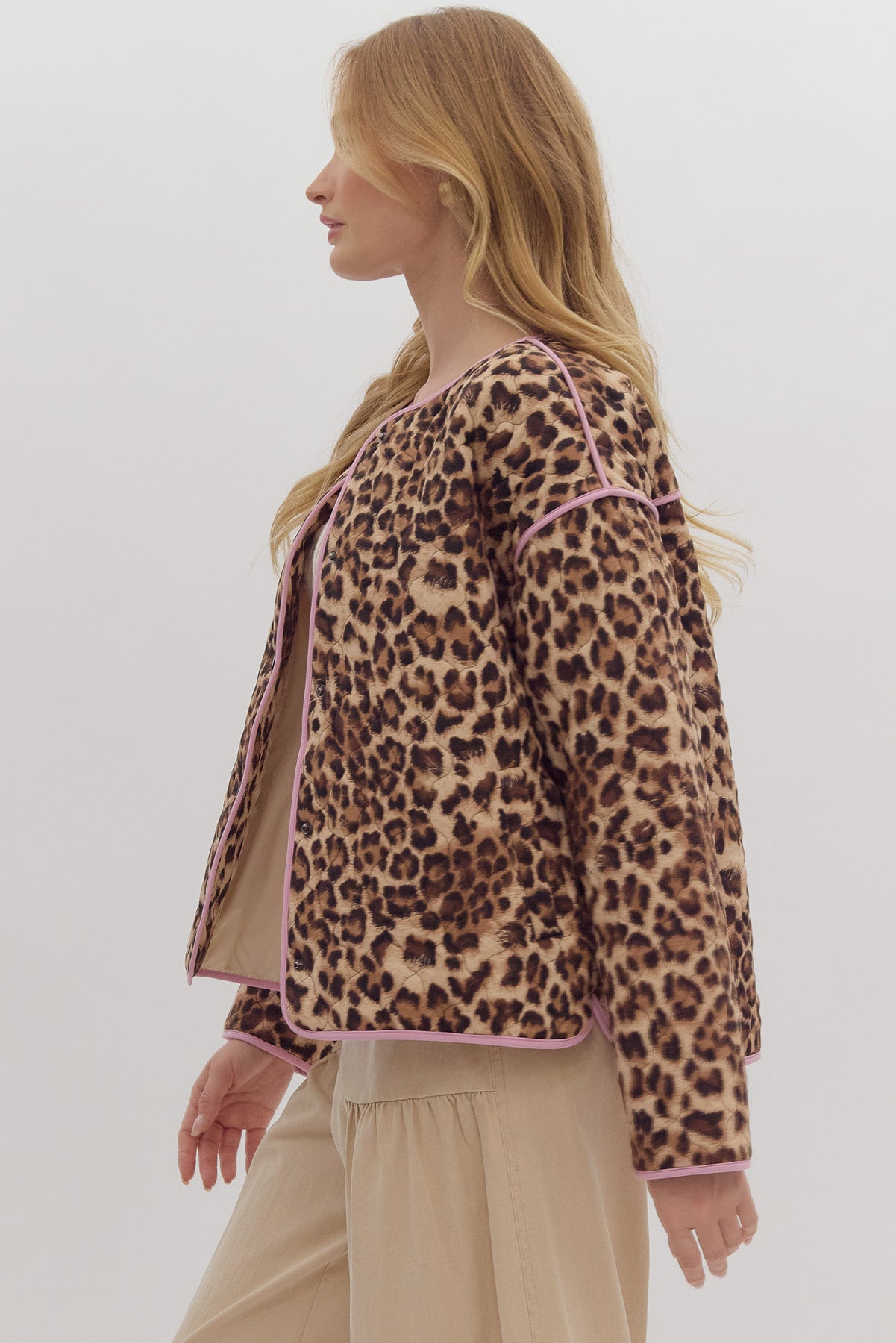 Leopard print long sleeve snap buttons jacket w/ pockets at side. Contrast trim.