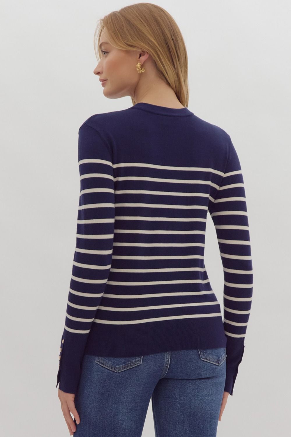 Navy stripe print long sleeve round neck top w/ button up detail at cuff.