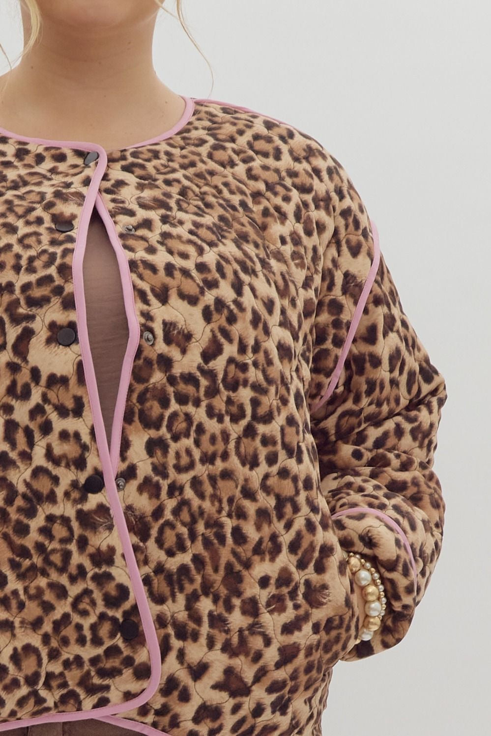 Leopard print long sleeve snap buttons jacket w/ pockets at side. Contrast trim.