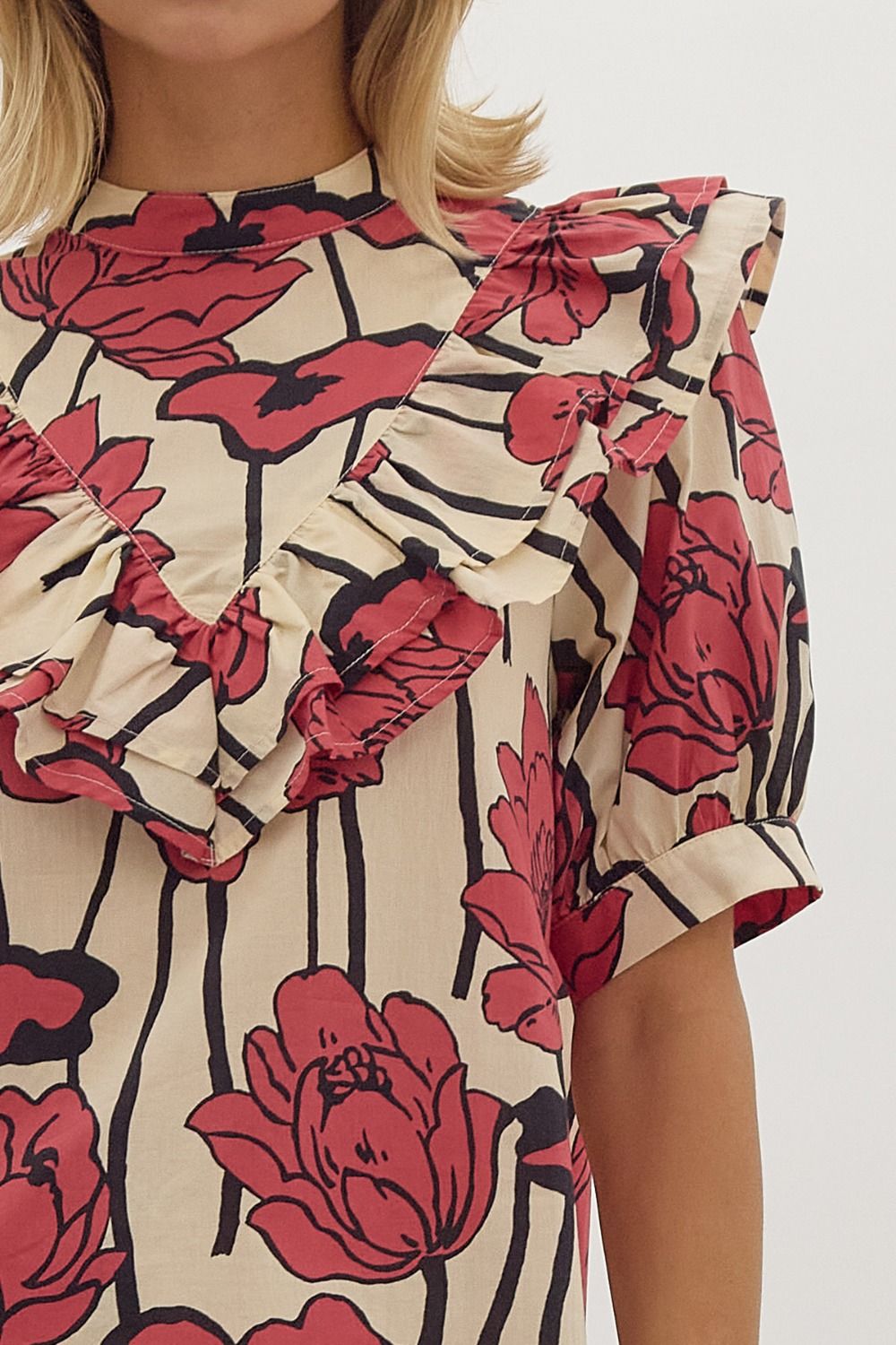 Floral print, mock neck short sleeve top w/ Ruffle overlay detail. Button at back
