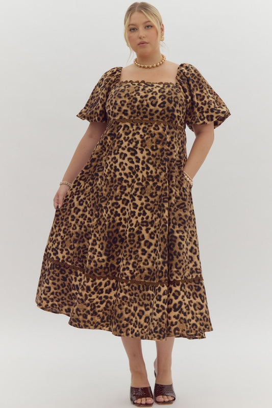 Cheetah print square neck bubble sleeve midi dress w/ ric rac trim. Elastic at cuff. Smocking at back. Pockets.