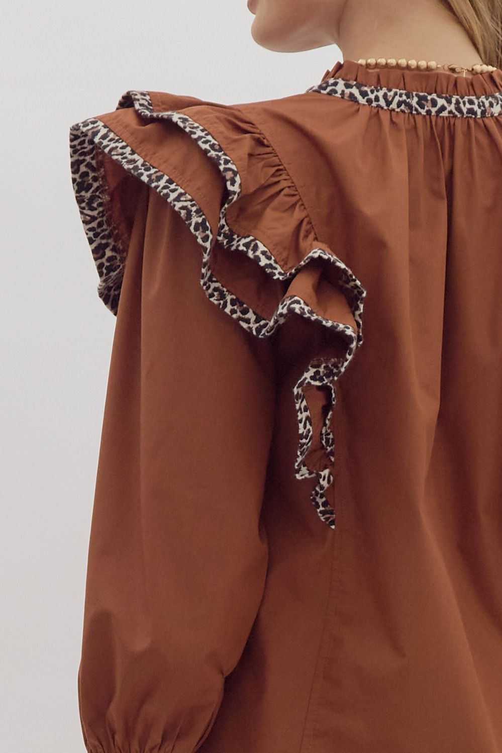 Solid long sleeve ruffled v-neck top w/ leopard print trim detail
