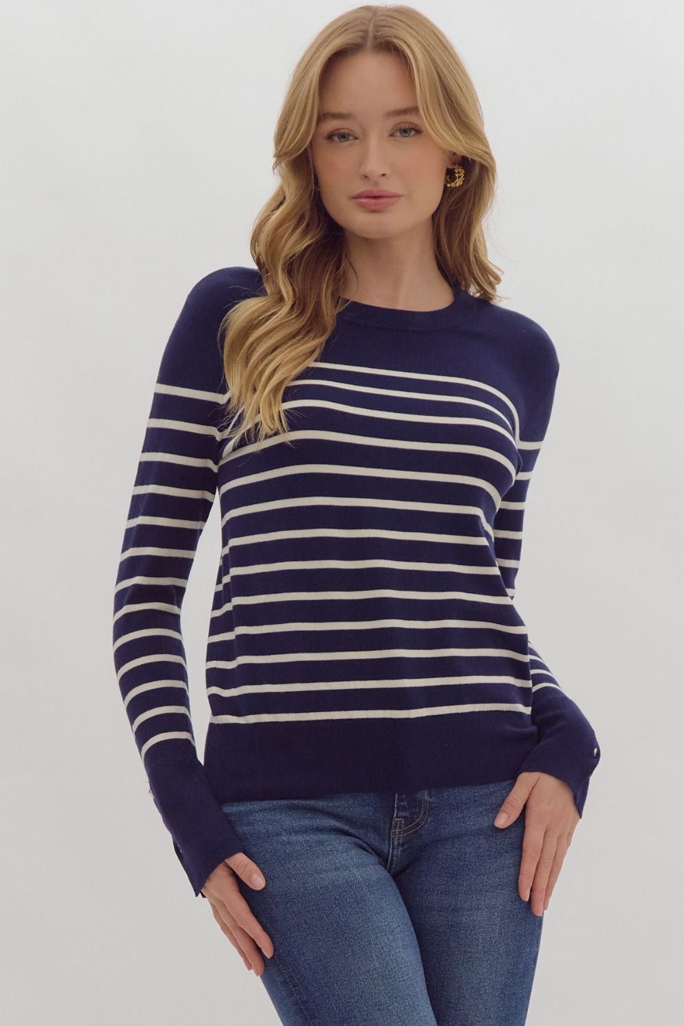 Navy stripe print long sleeve round neck top w/ button up detail at cuff.