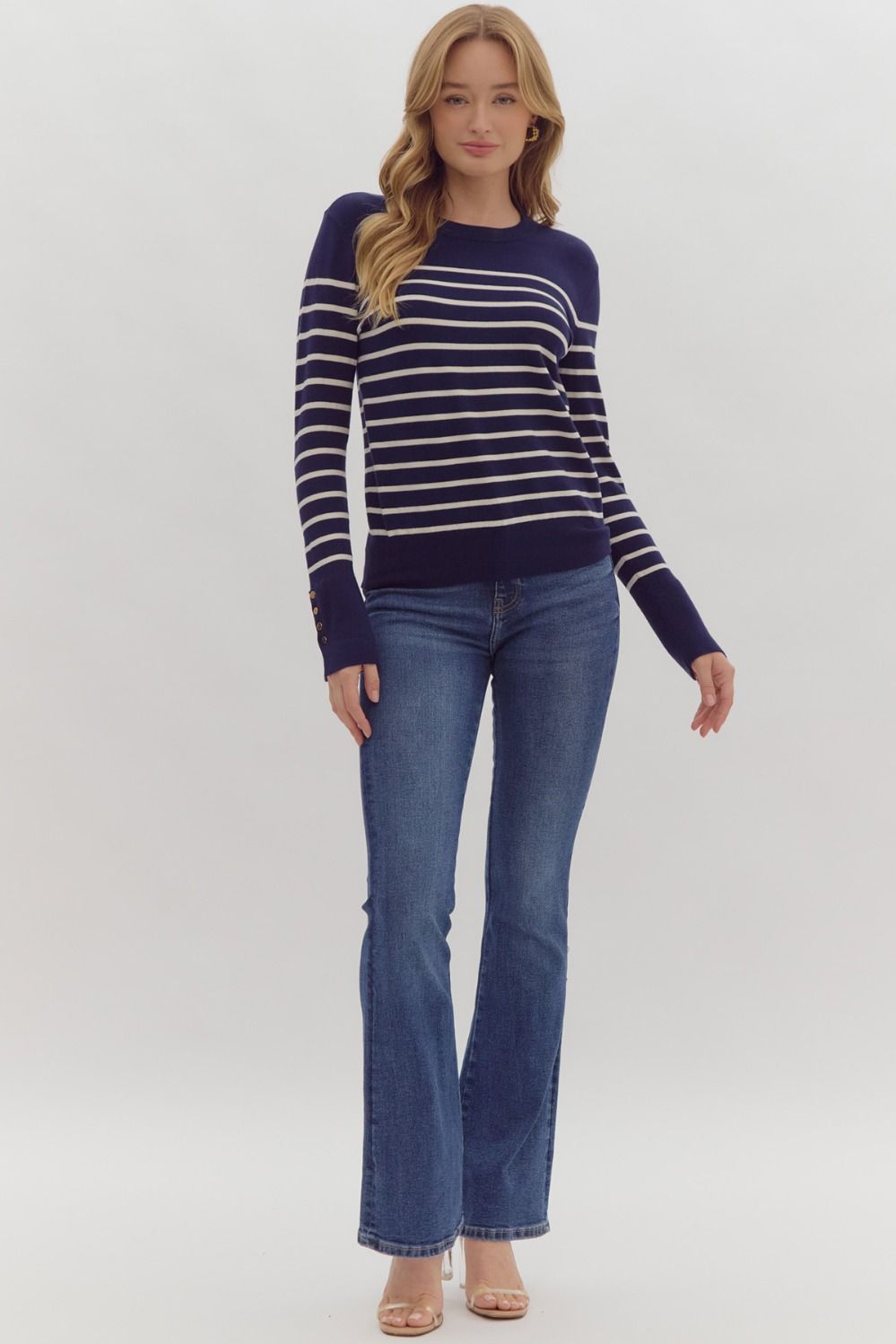 Navy stripe print long sleeve round neck top w/ button up detail at cuff.