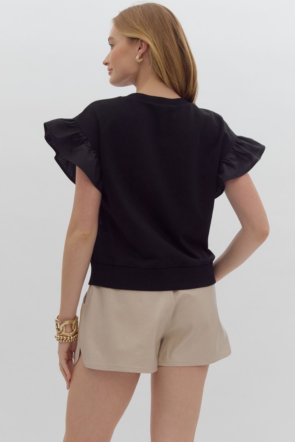 Solid short sleeve round neck top w/ ruffled sleeves. Ribbon detail @ bust.