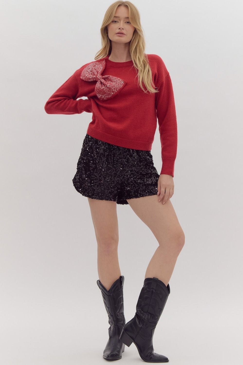 Solid long sleeved sweater knit pullover w/ over sized sequin bow at front