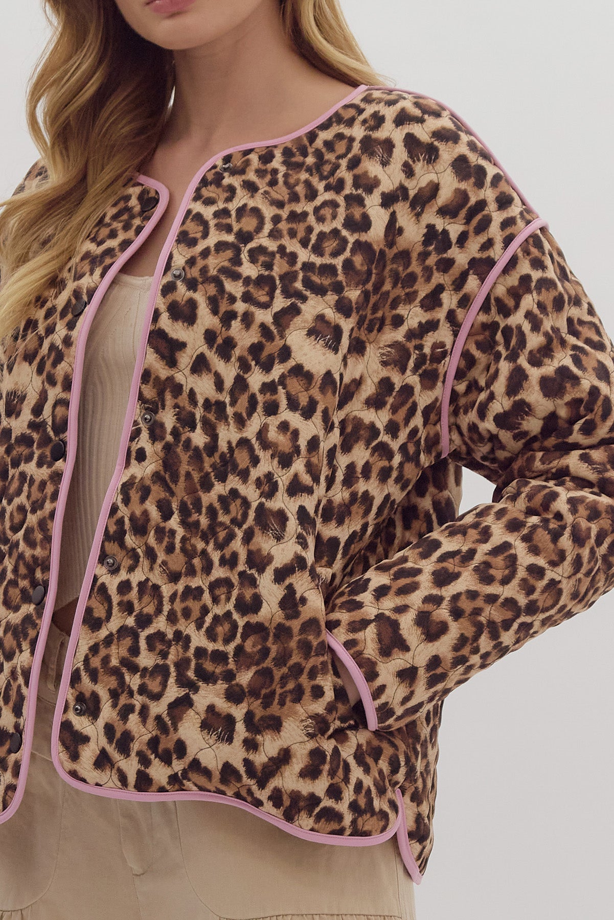 Leopard print long sleeve snap buttons jacket w/ pockets at side. Contrast trim.