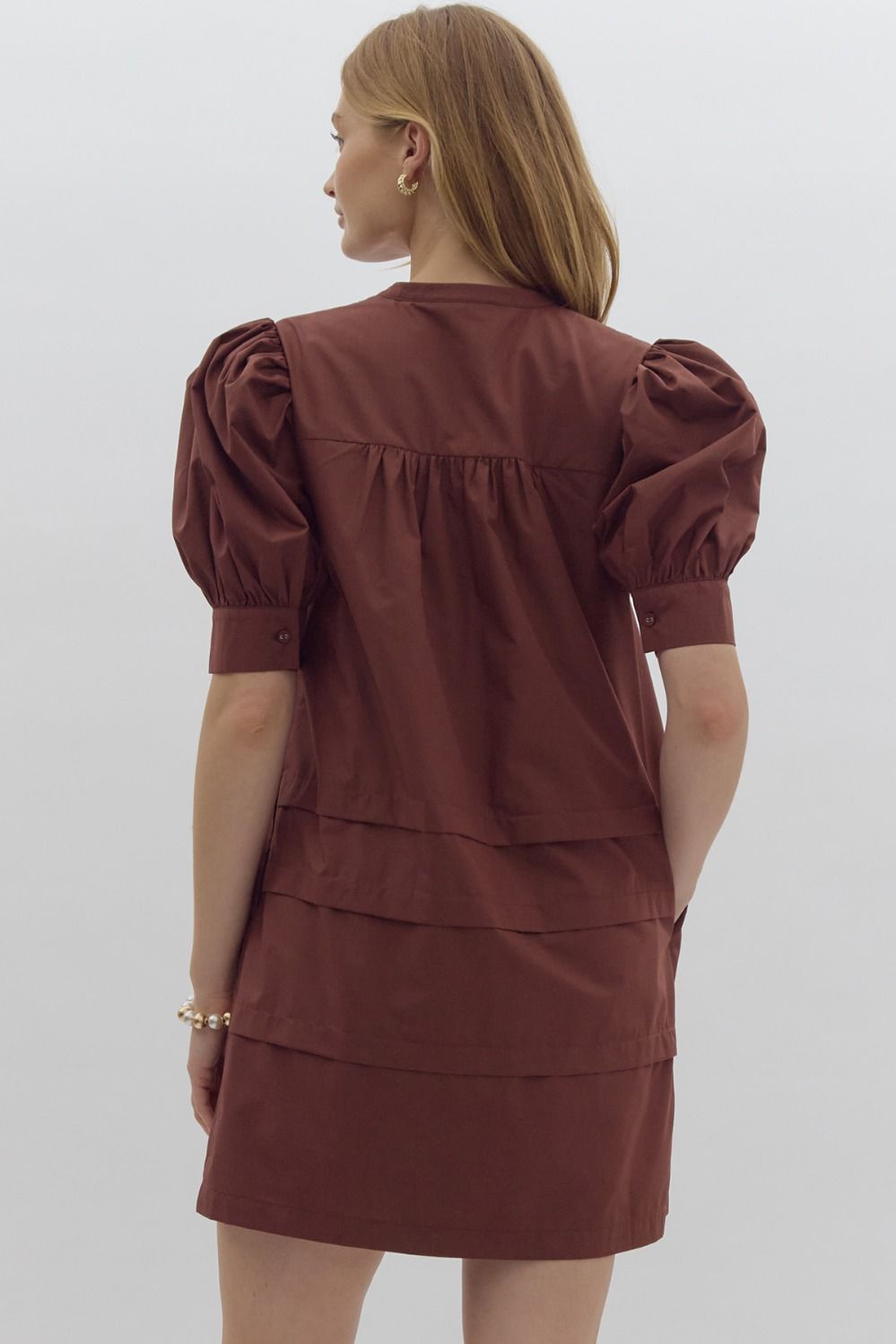 Solid pin tucked short sleeve mini dress w/ pockets, puff sleeves, & button detail at bust