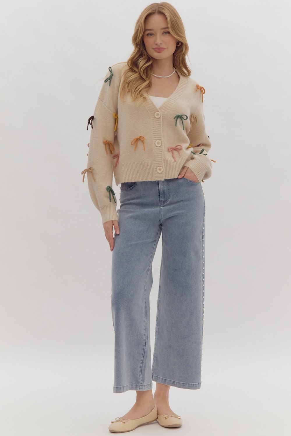 Solid long sleeve button down cropped cardigan w/ multi color bow appliqués