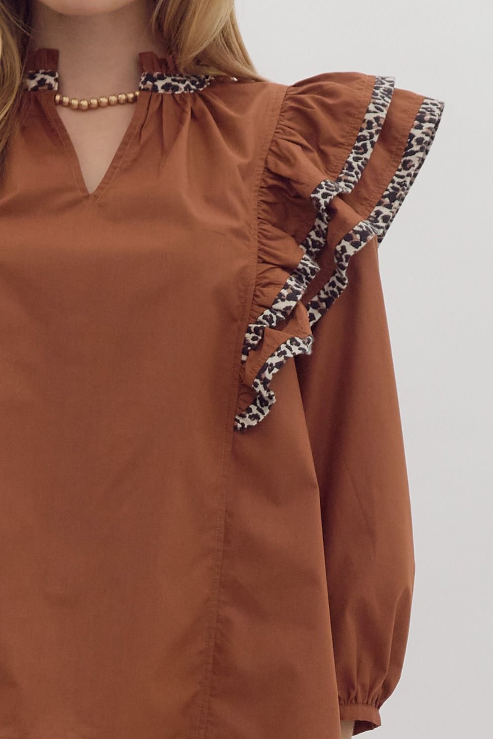 Solid long sleeve ruffled v-neck top w/ leopard print trim detail